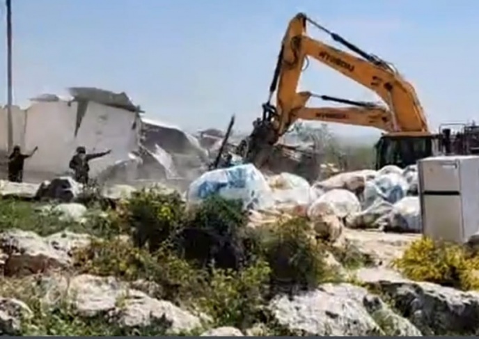 The occupation demolishes a commercial facility in Deir Ballut